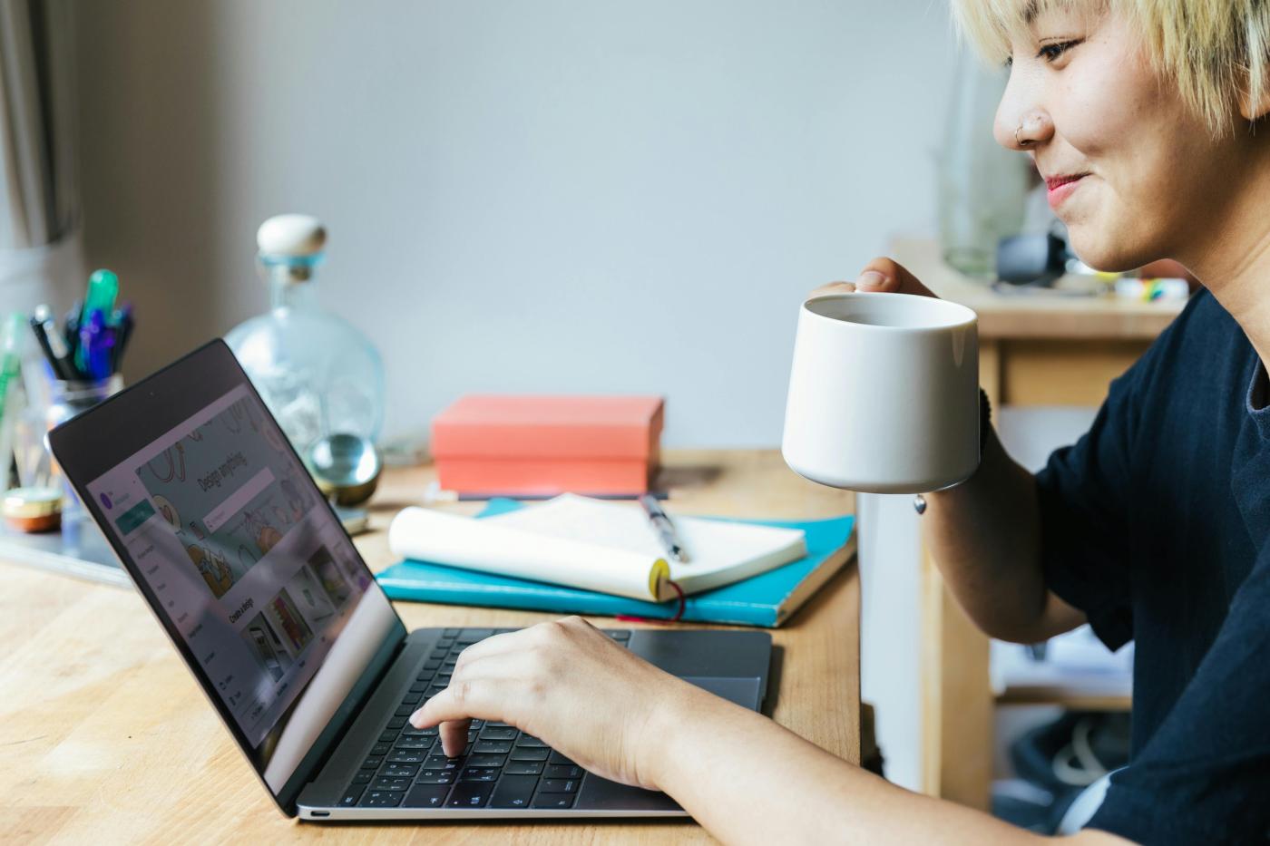 Happy woman browsing laptop at home