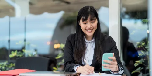 young woman outside using phone